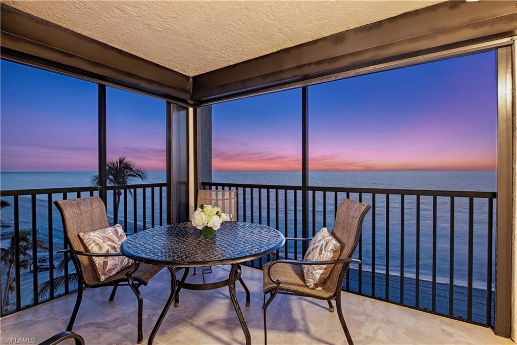 Sunroom / solarium featuring a water view