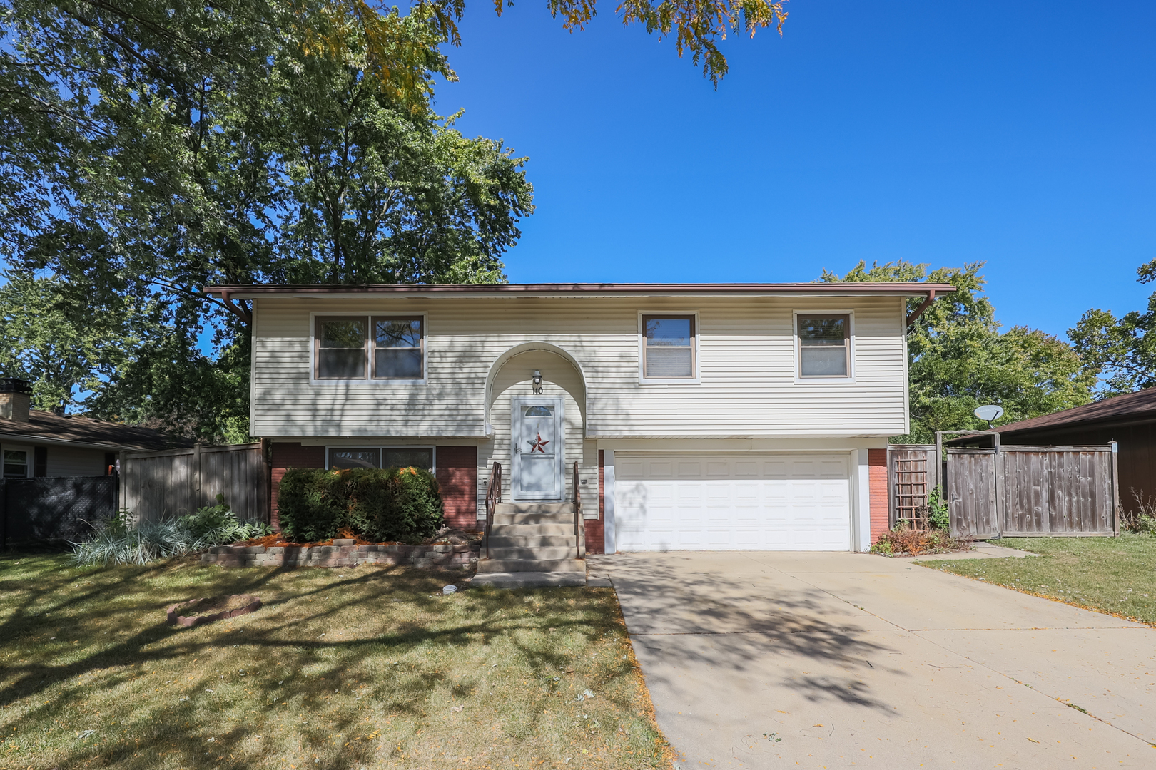 a view of a house with a yard and garage