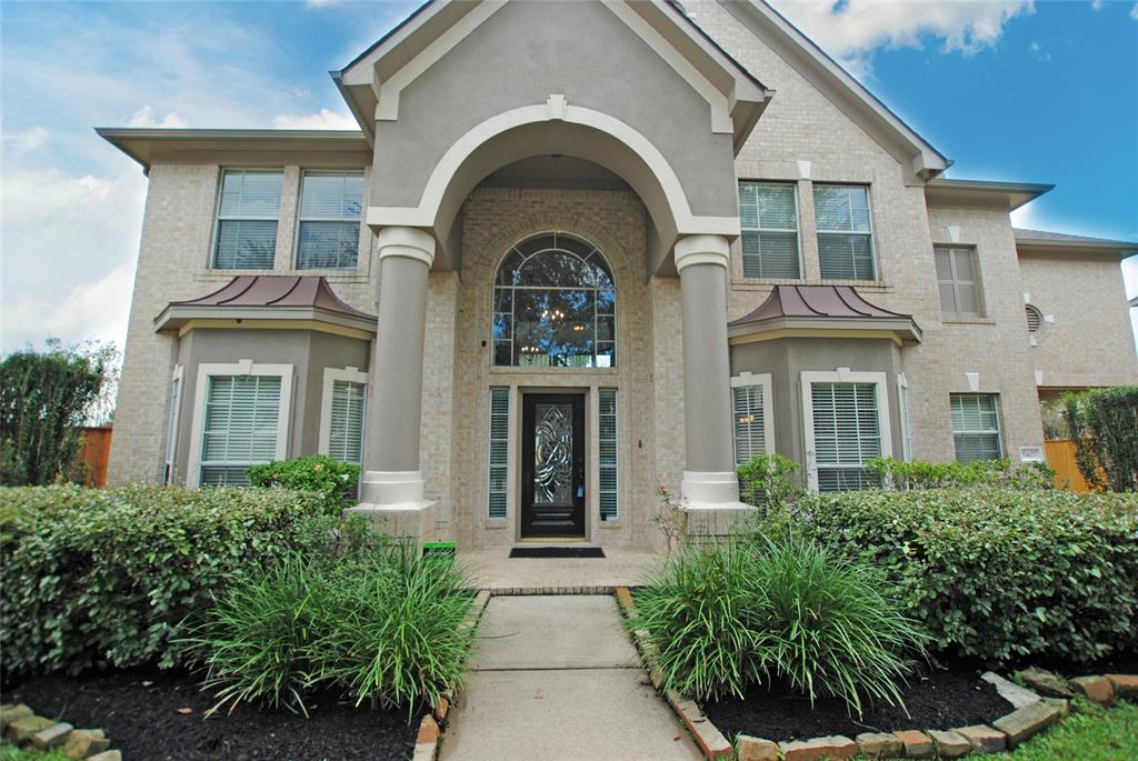 a view of a brick house with large windows