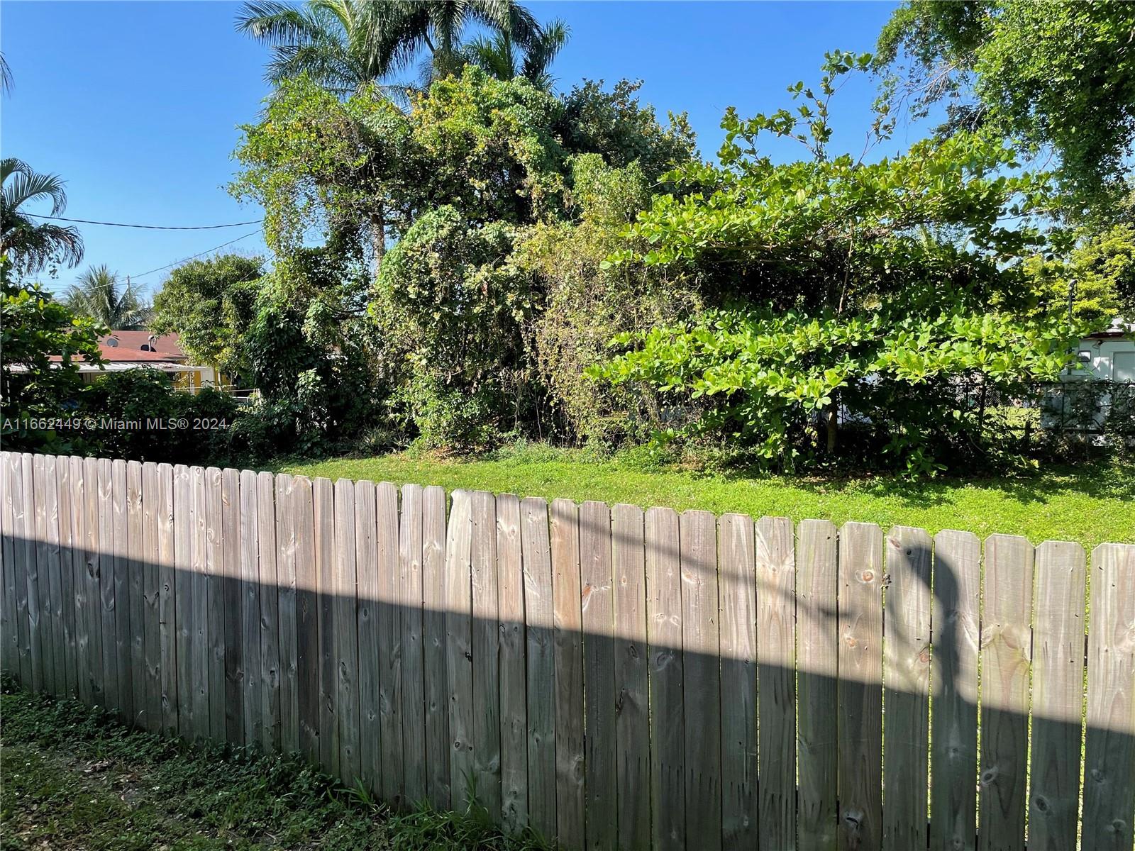 a view of outdoor space with a wooden fence