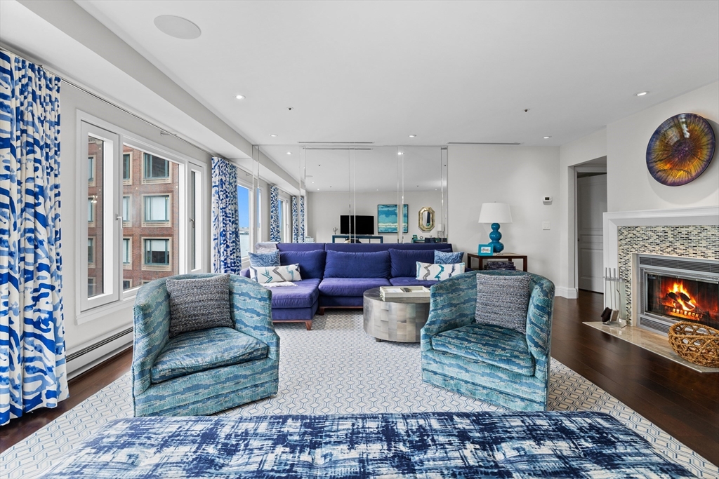 a living room with furniture a rug and a fireplace