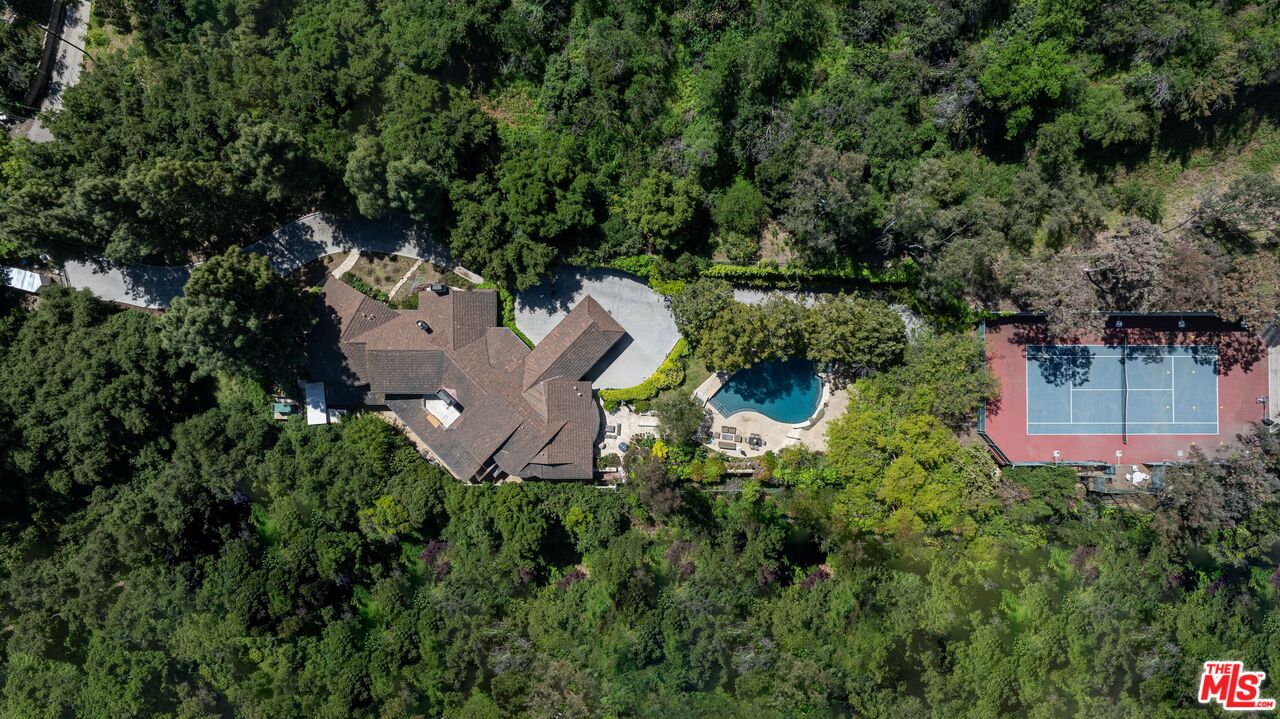 an aerial view of a house with a yard and lake view