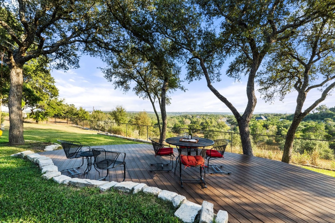 a view of a swimming pool with a patio and a yard