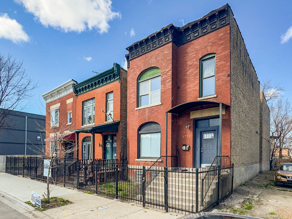 a front view of a residential apartment building with a yard