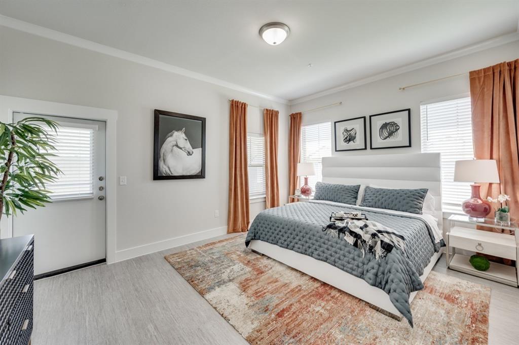 a bedroom with a large bed and potted plant