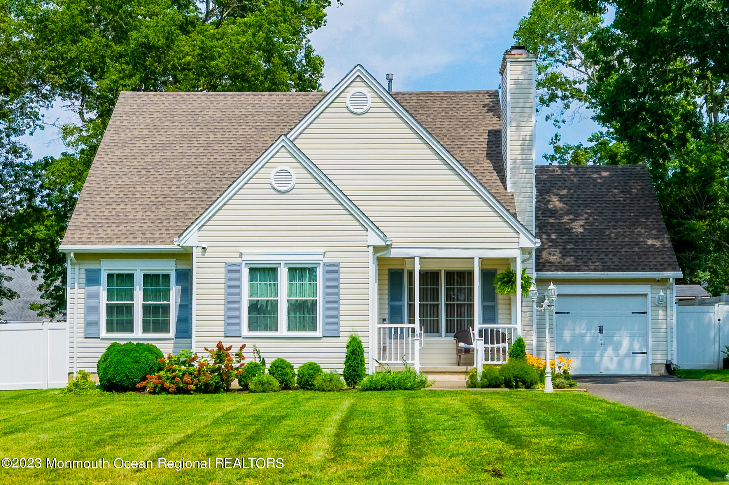 a front view of a house with a yard and porch