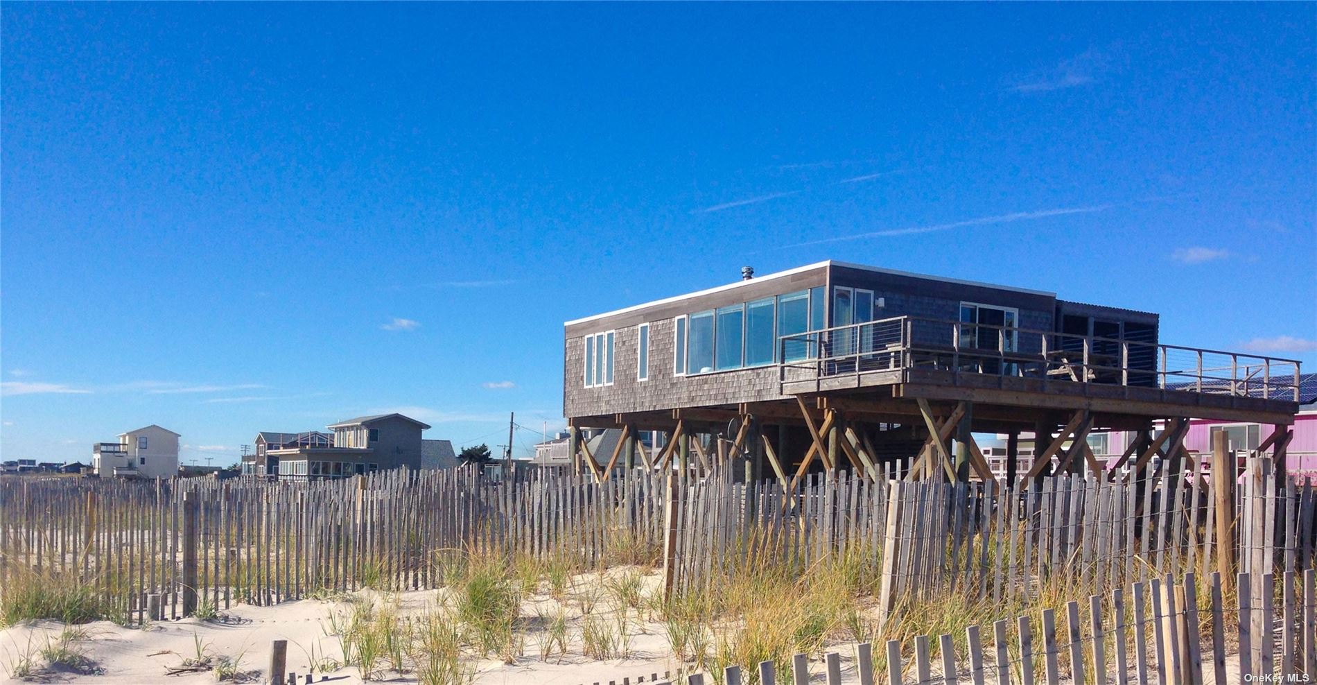 a view of a house with a wooden deck