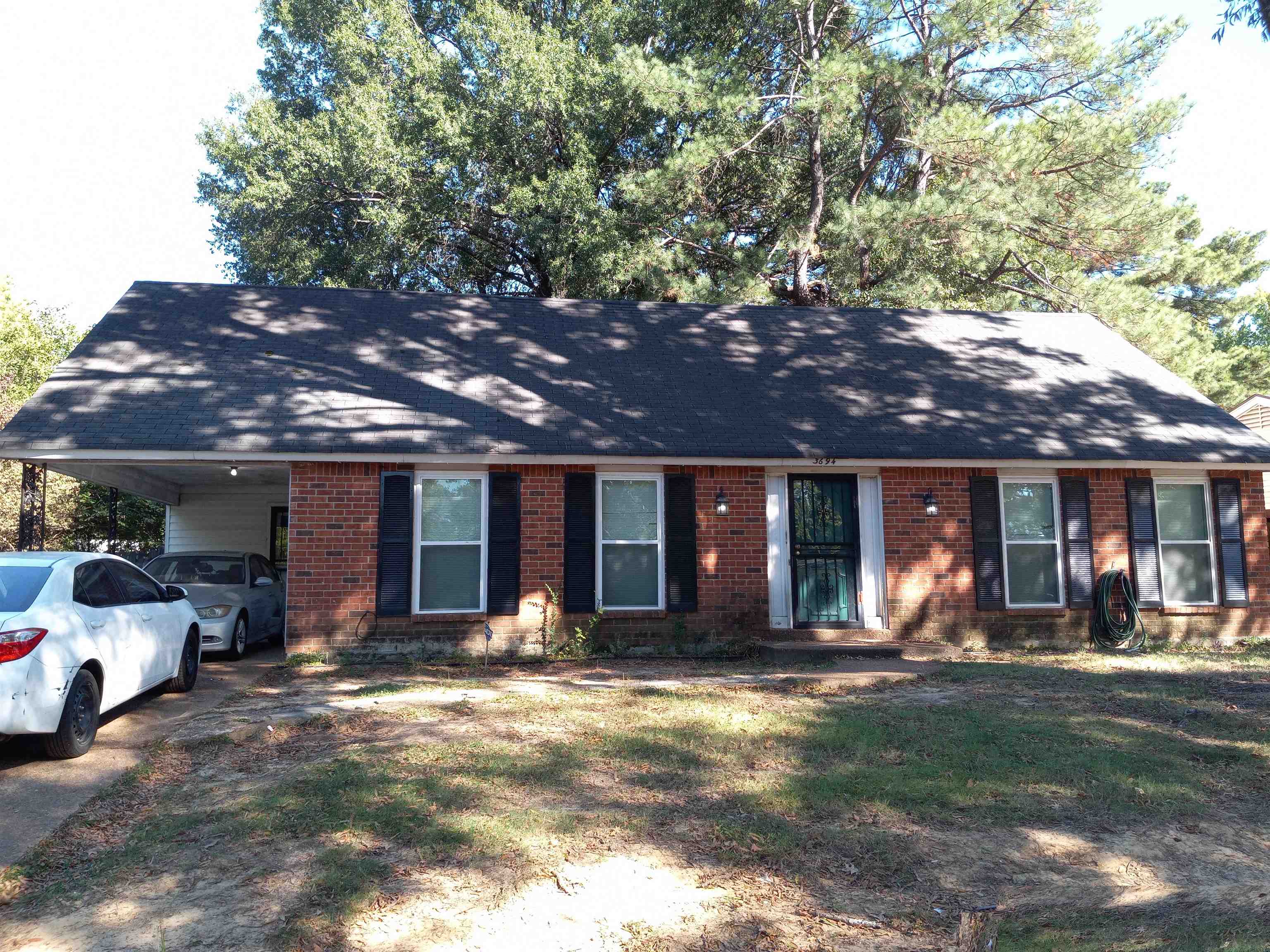 Ranch-style house featuring a carport