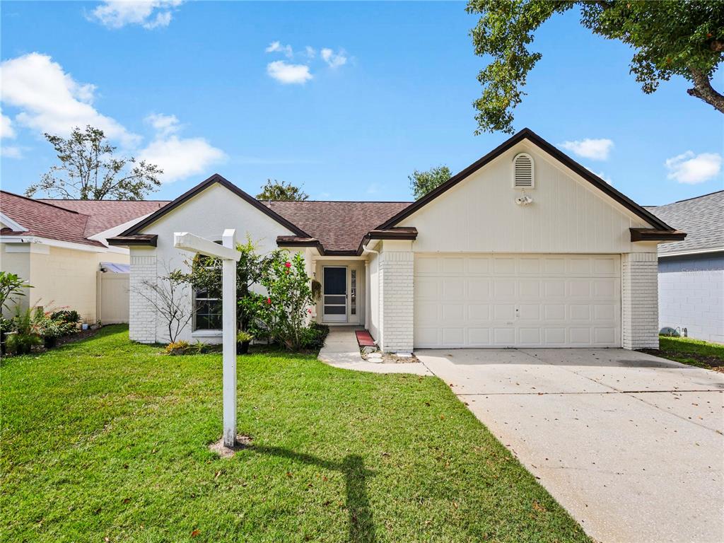 a view of a house with yard and tree s