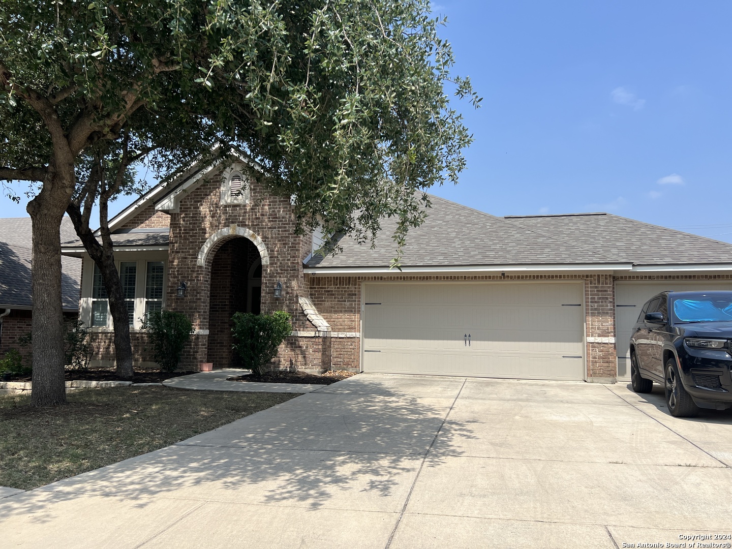 a front view of a house with parking area