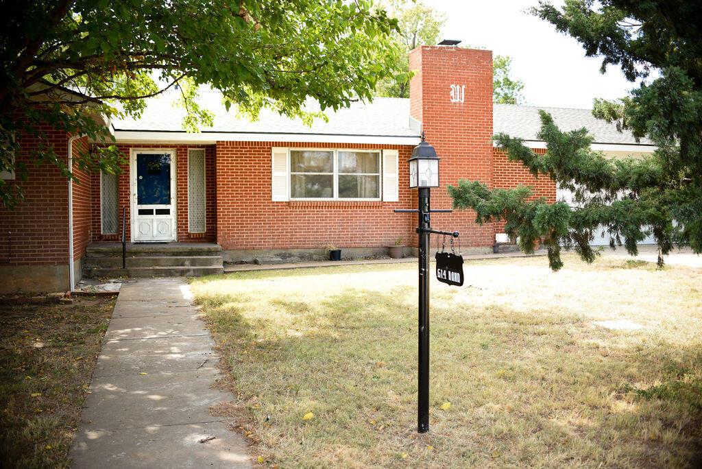 a front view of a house with yard