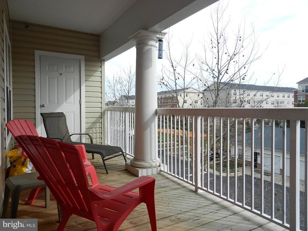 a view of a balcony with furniture