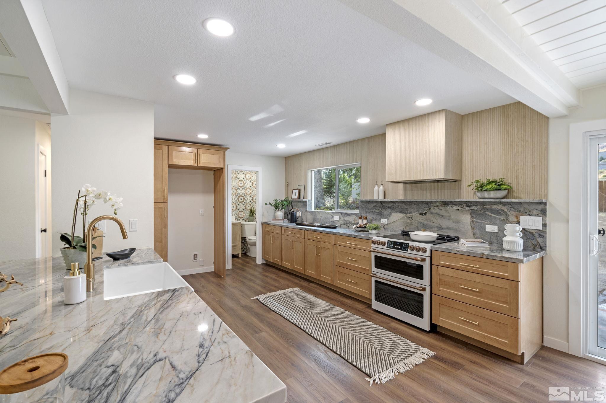 a kitchen with a sink stove and cabinets