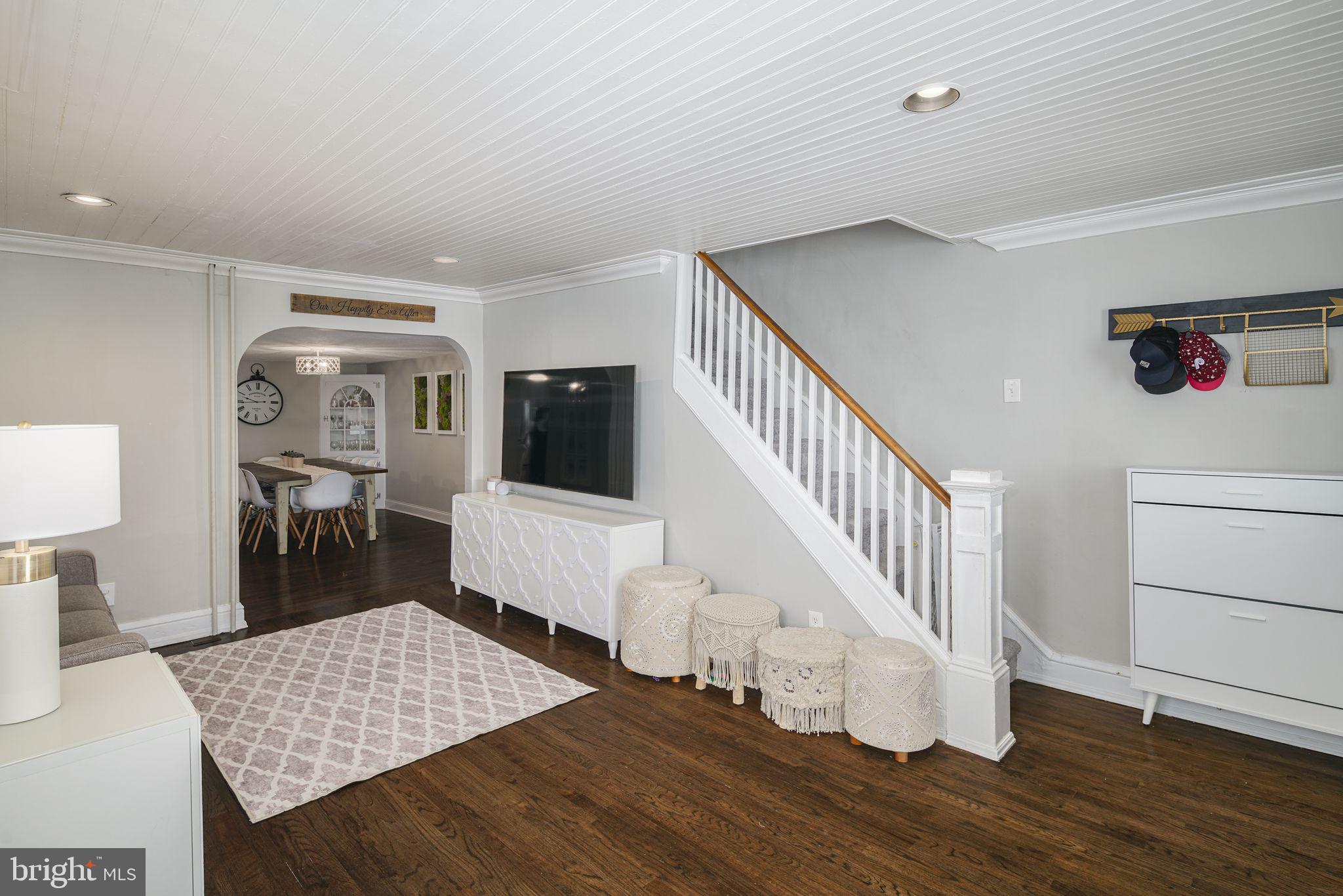 a living room with wooden floor and furniture