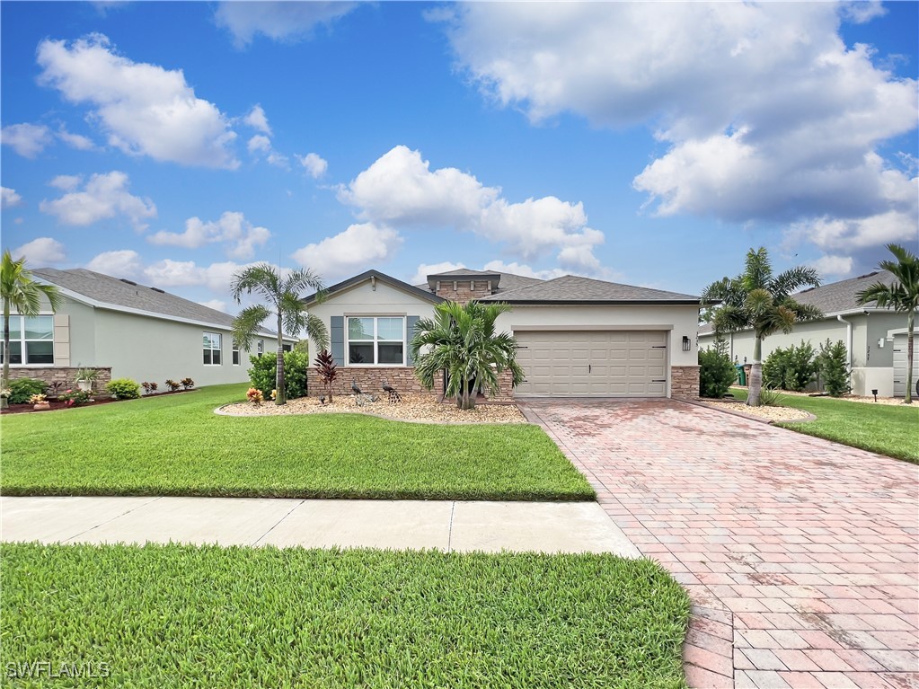 a front view of a house with a yard and garage