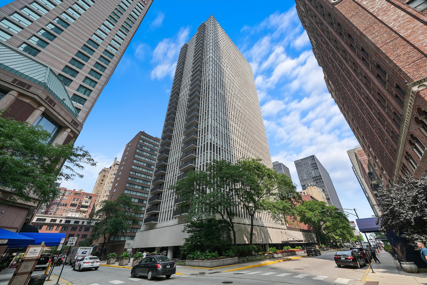 a view of a tall building next to a road