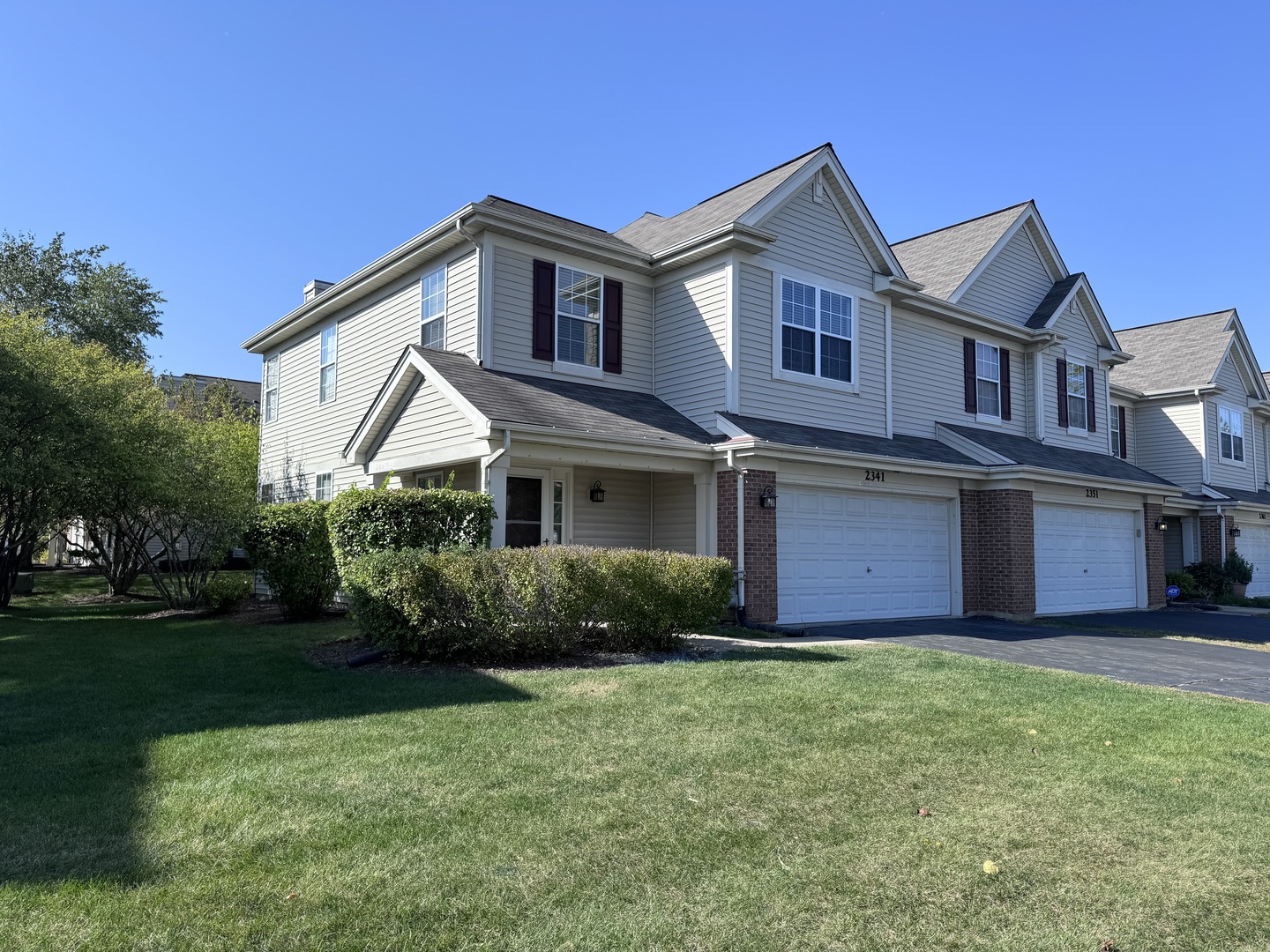 a front view of a house with a garden and yard