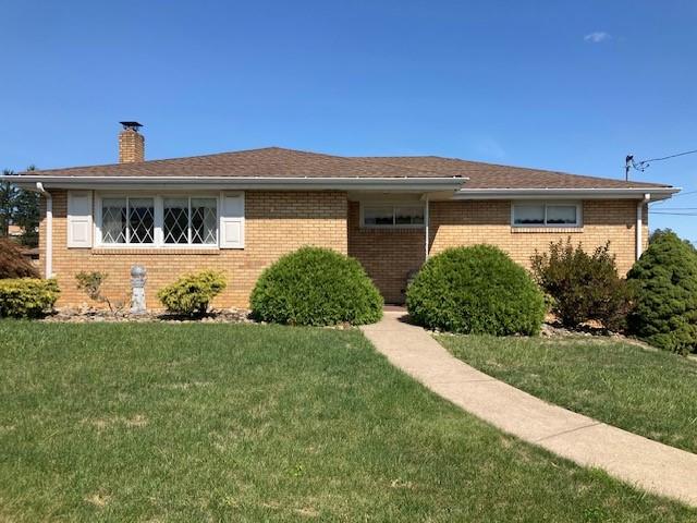 a front view of house with yard and green space