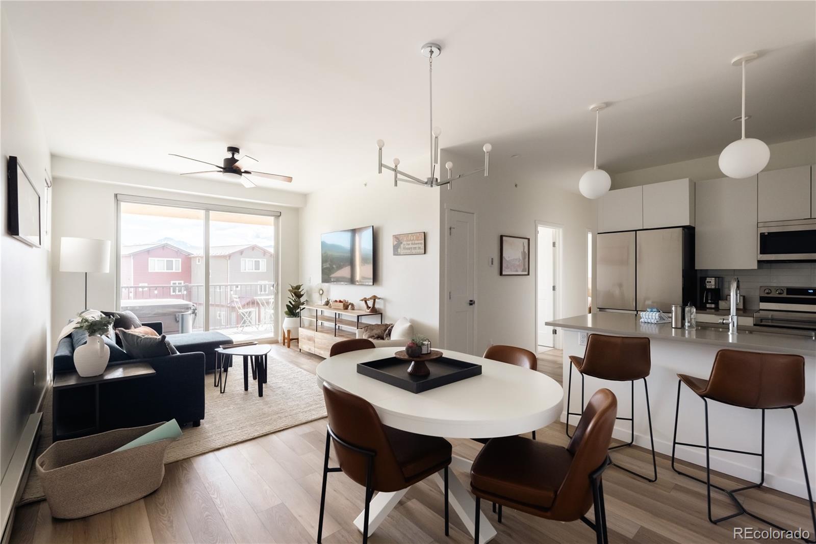 a view of a dining room and livingroom furniture wooden floor and a chandelier