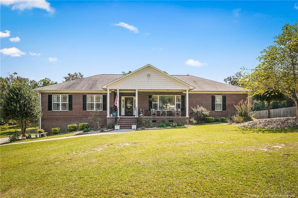 a front view of house with yard and swimming pool