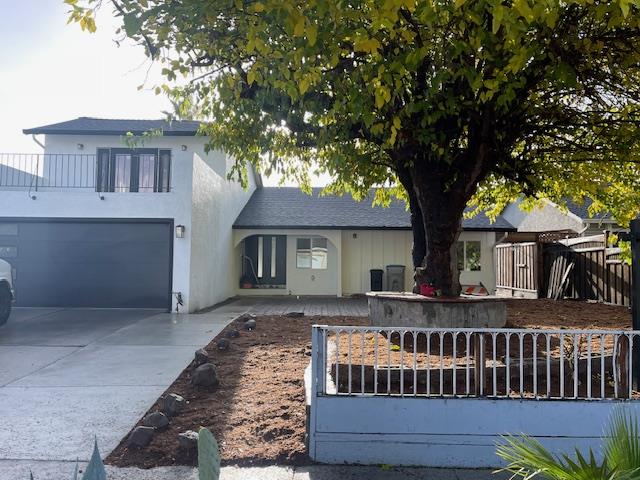 a view of house with a yard and a large tree