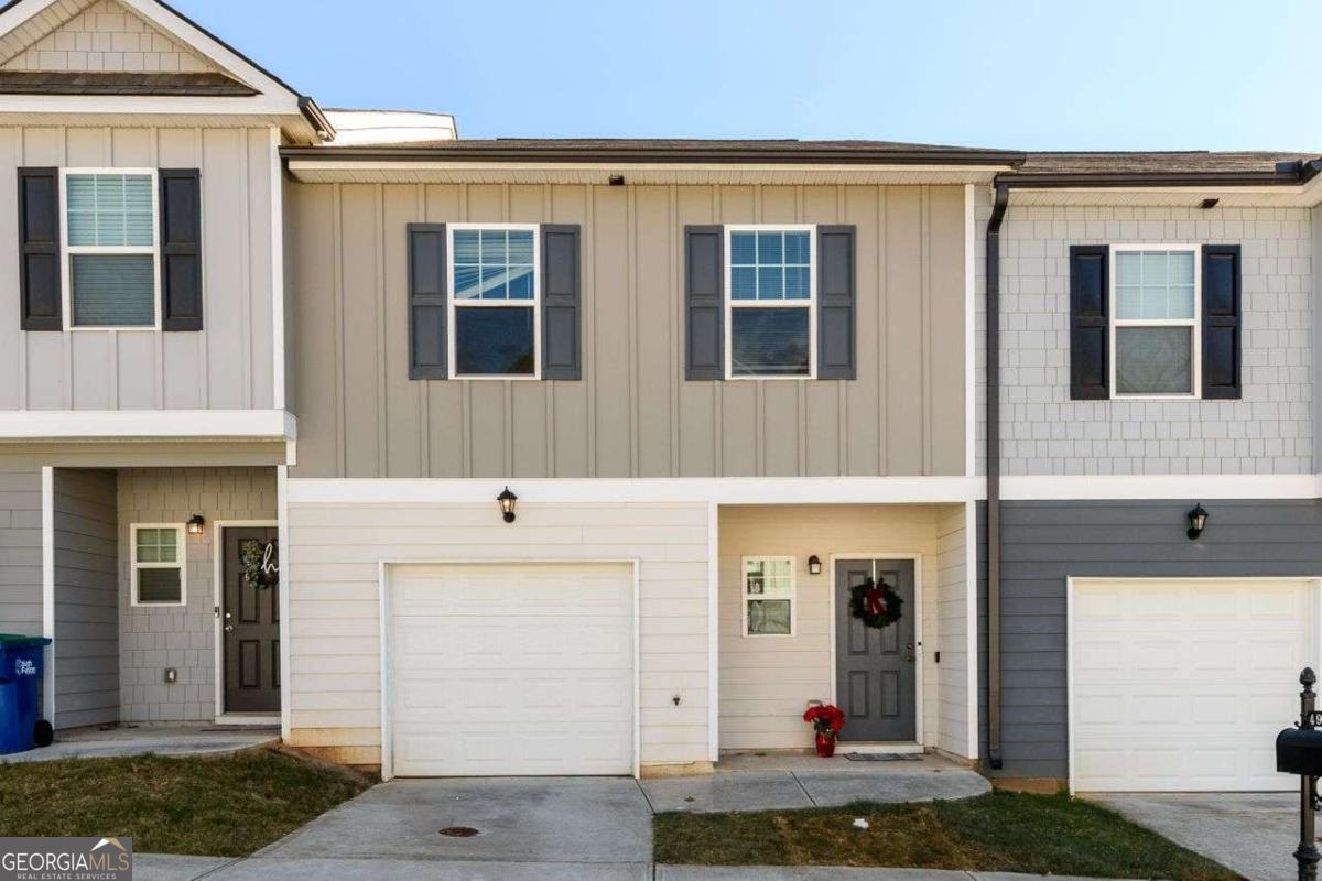 a front view of a house with white walls