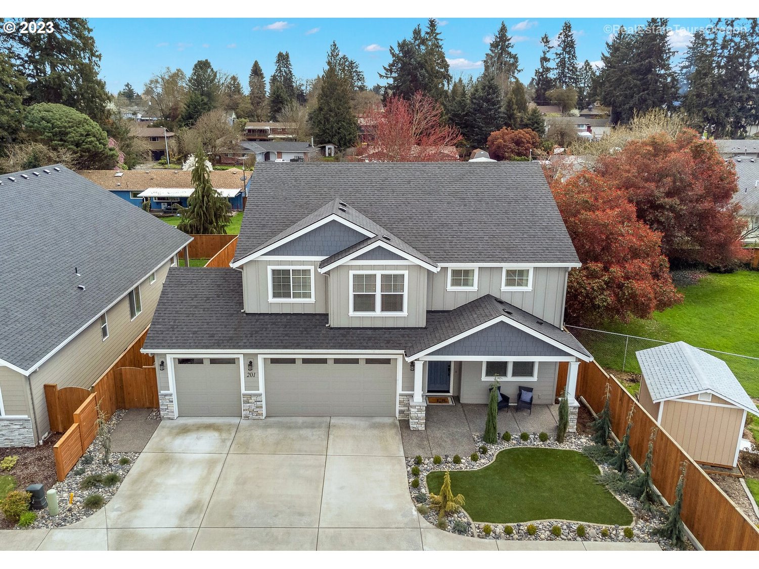 an aerial view of a house with a yard