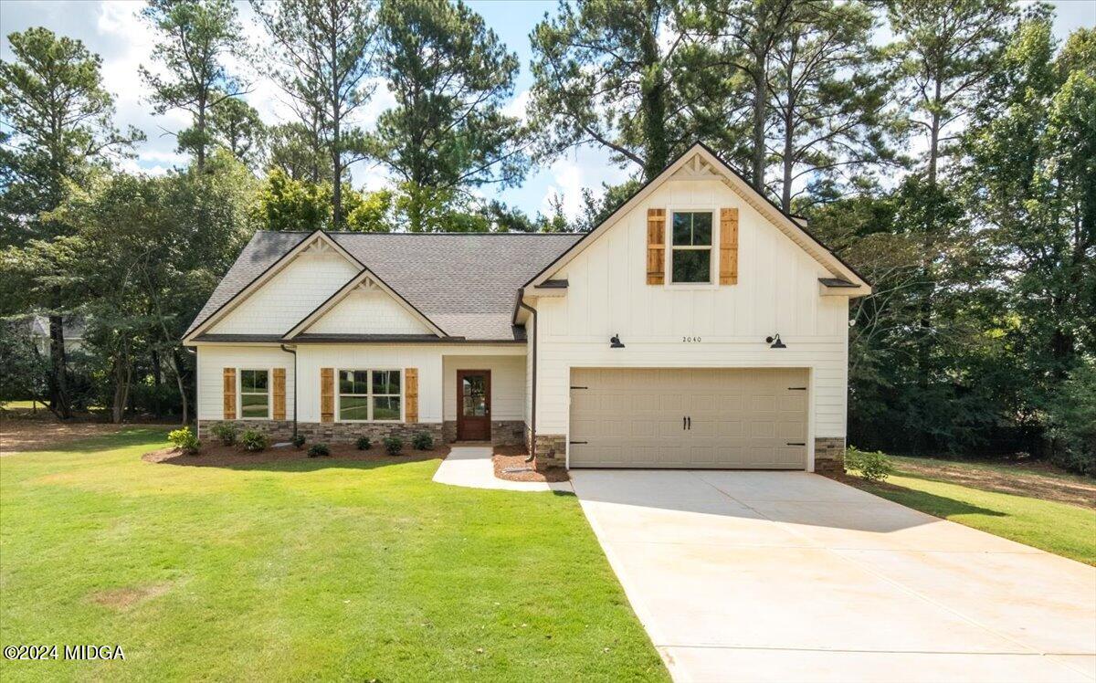 a front view of house with yard and green space