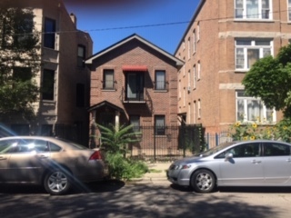 a front view of a house with parking space