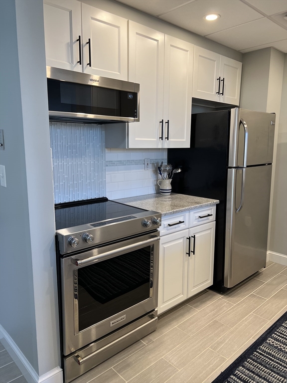 a kitchen with a stove and a refrigerator