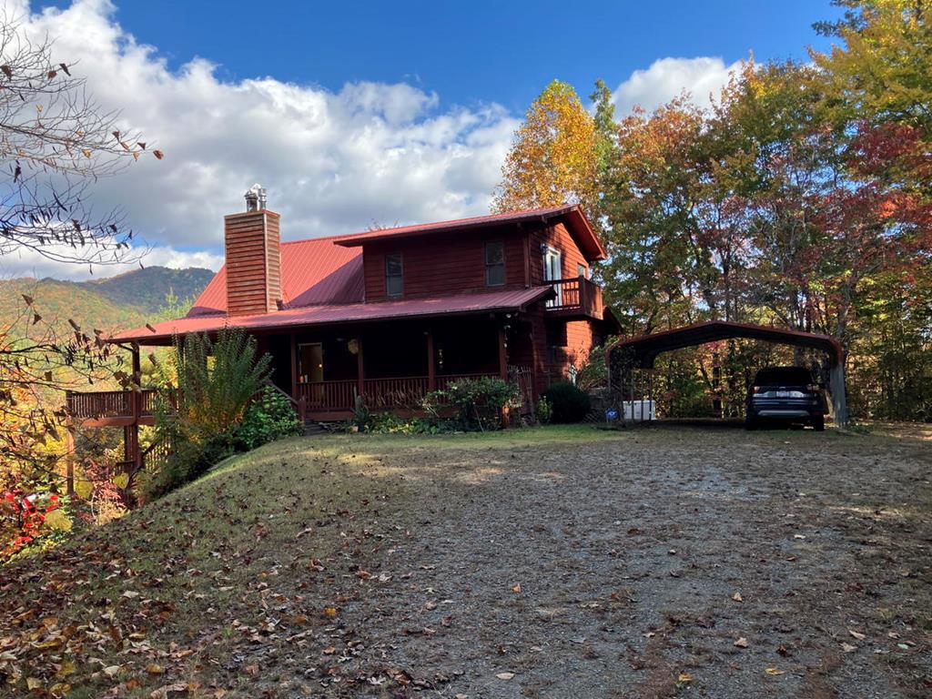 a view of a house with a yard and pathway