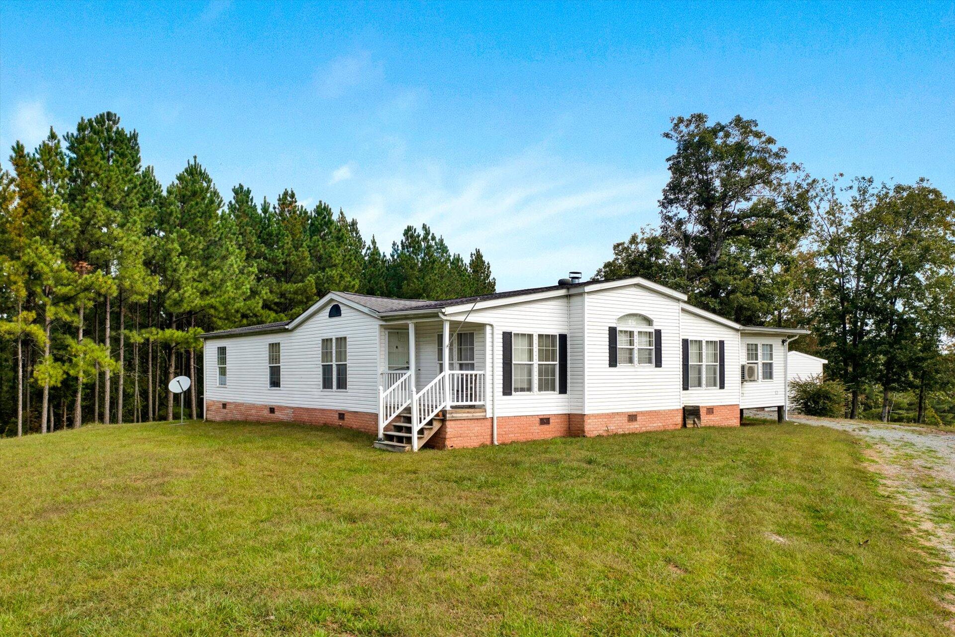 a front view of house with yard and green space