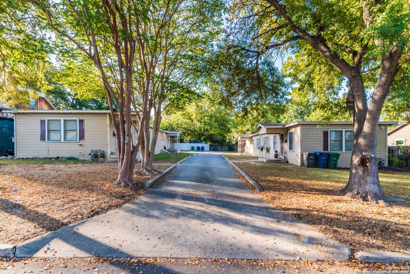 a view of a yard with a large tree