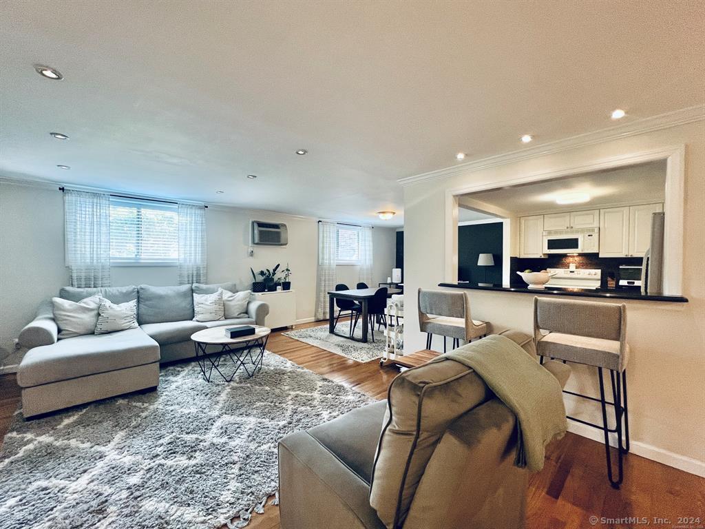 a living room with furniture and view of kitchen