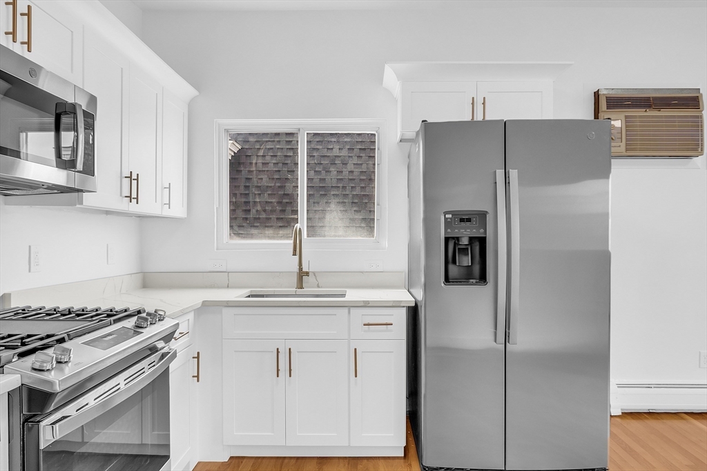 a kitchen with stainless steel appliances granite countertop a refrigerator sink and stove