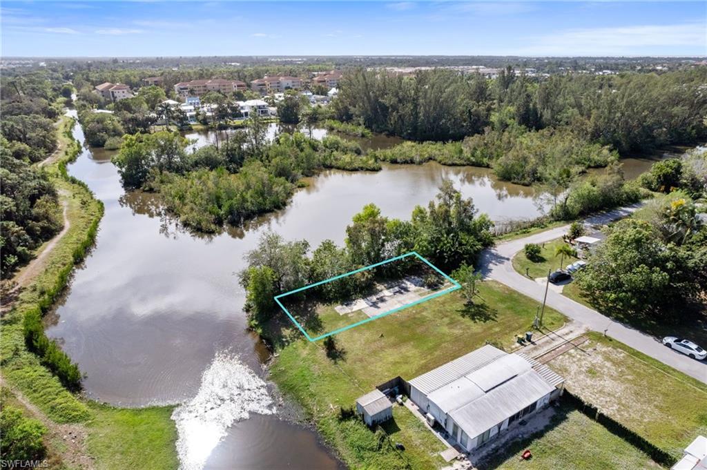 an aerial view of a house with swimming pool and lake view