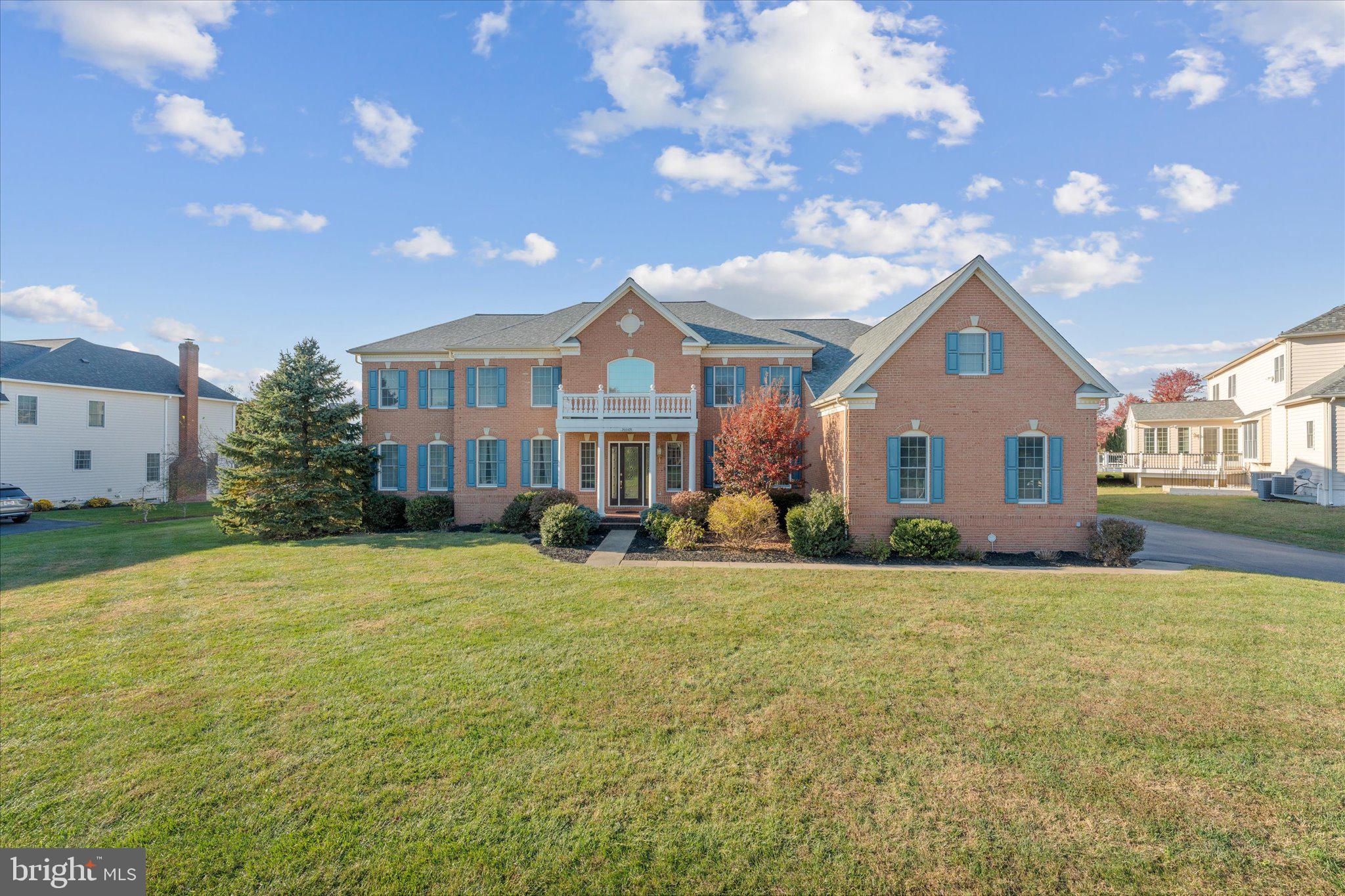 a front view of a house with yard porch and outdoor seating