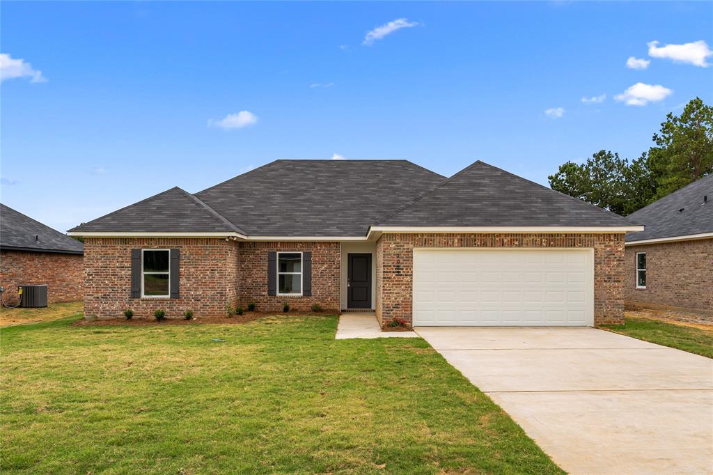 a front view of house with yard and garage