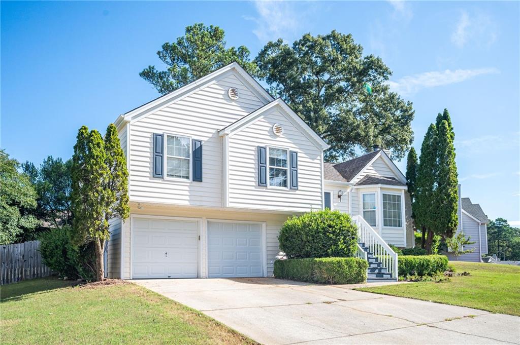 a view of a house with a yard