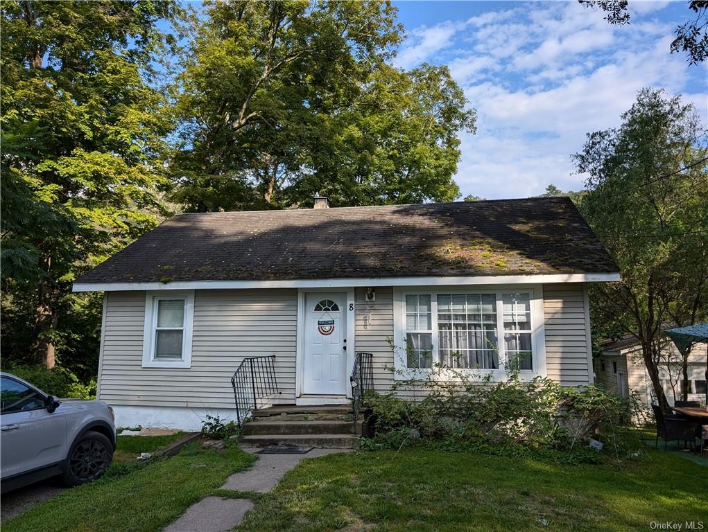 a front view of a house with a garden