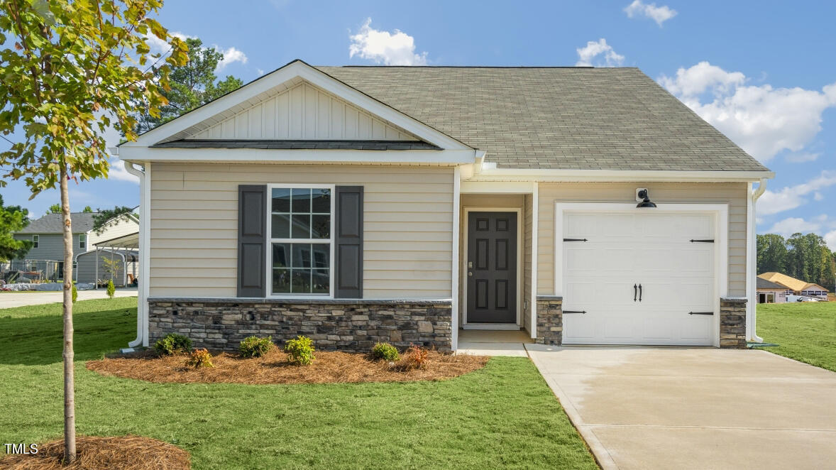 a front view of a house with a yard and garage