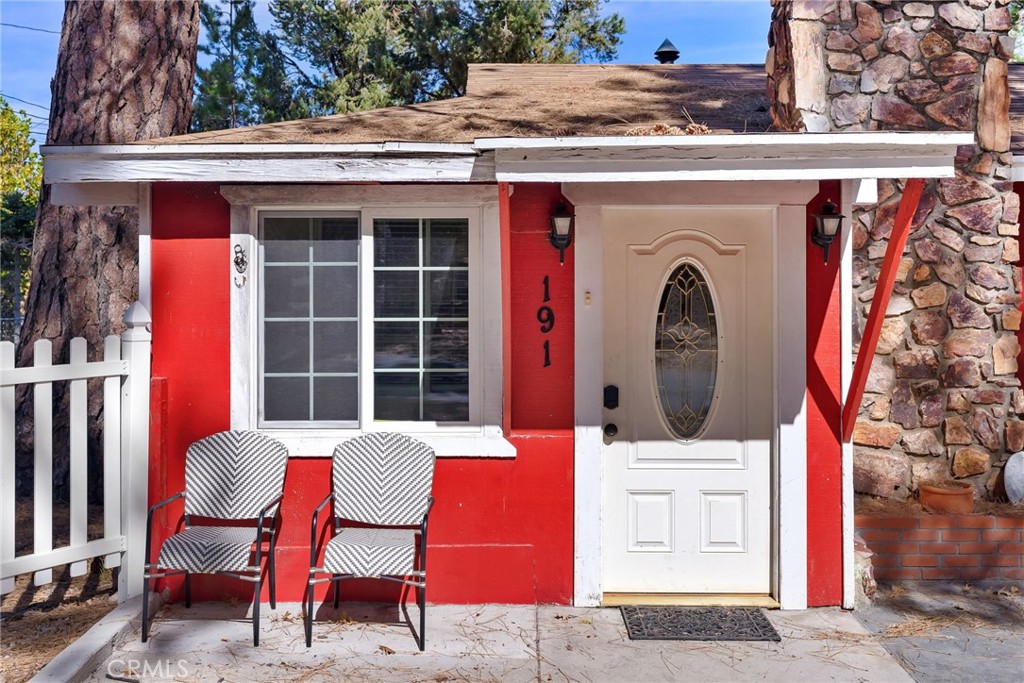 a view of a chairs and table in the back yard of the house