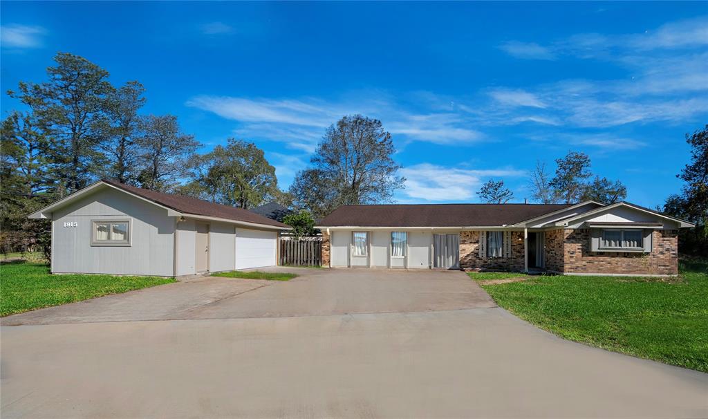 a front view of a house with a garden and yard