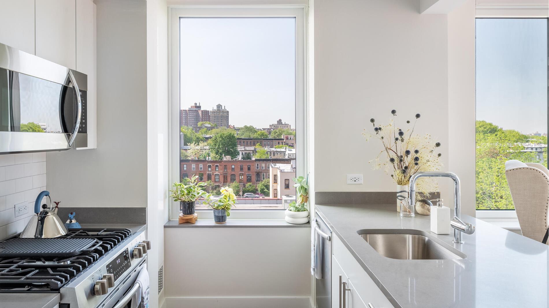 a kitchen with kitchen island a counter space a sink and appliances