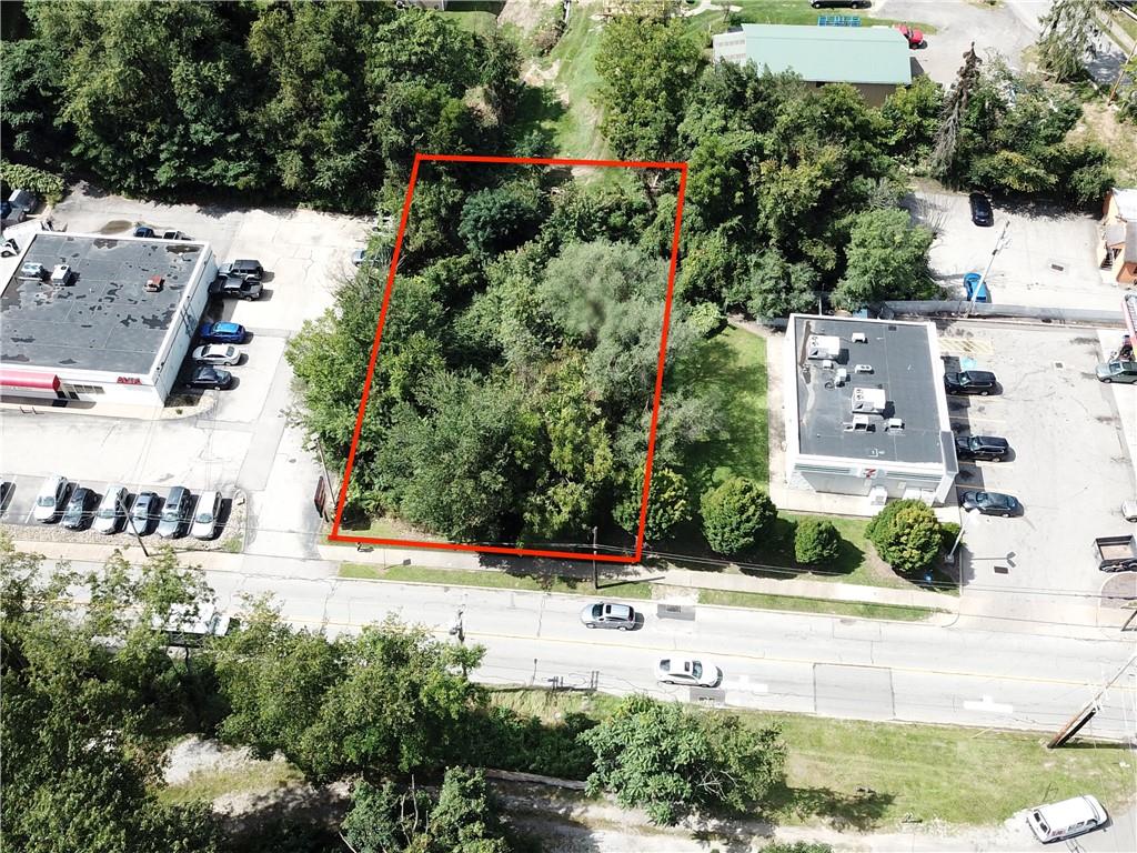 an aerial view of a house with yard and parking