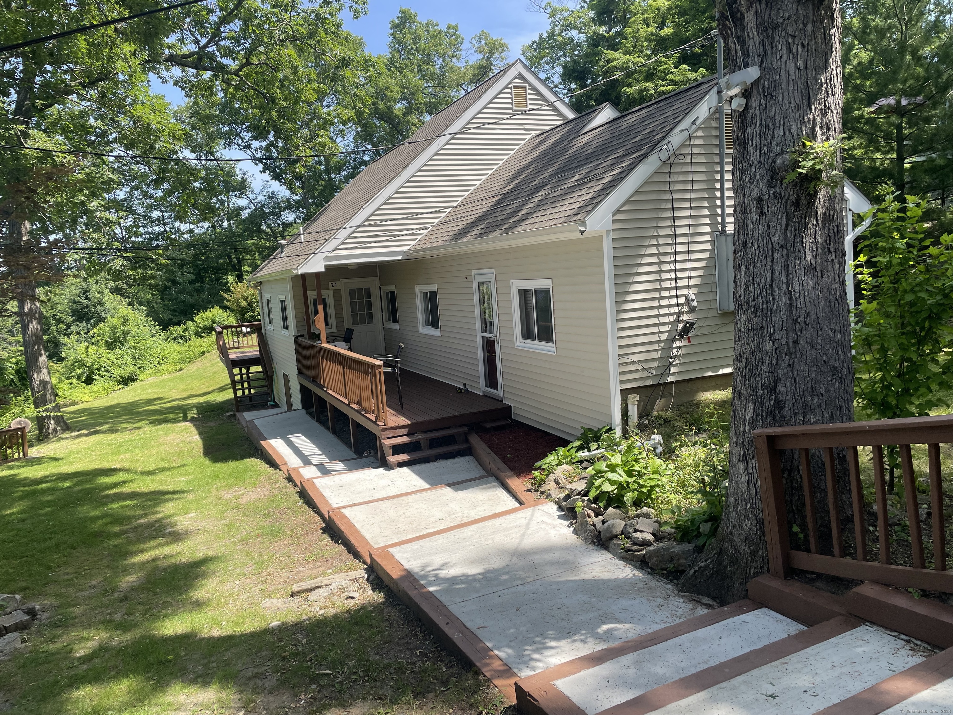 a view of a house with backyard and sitting area