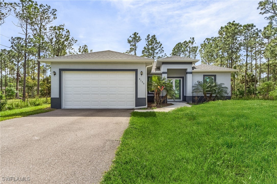 a front view of house with yard and green space