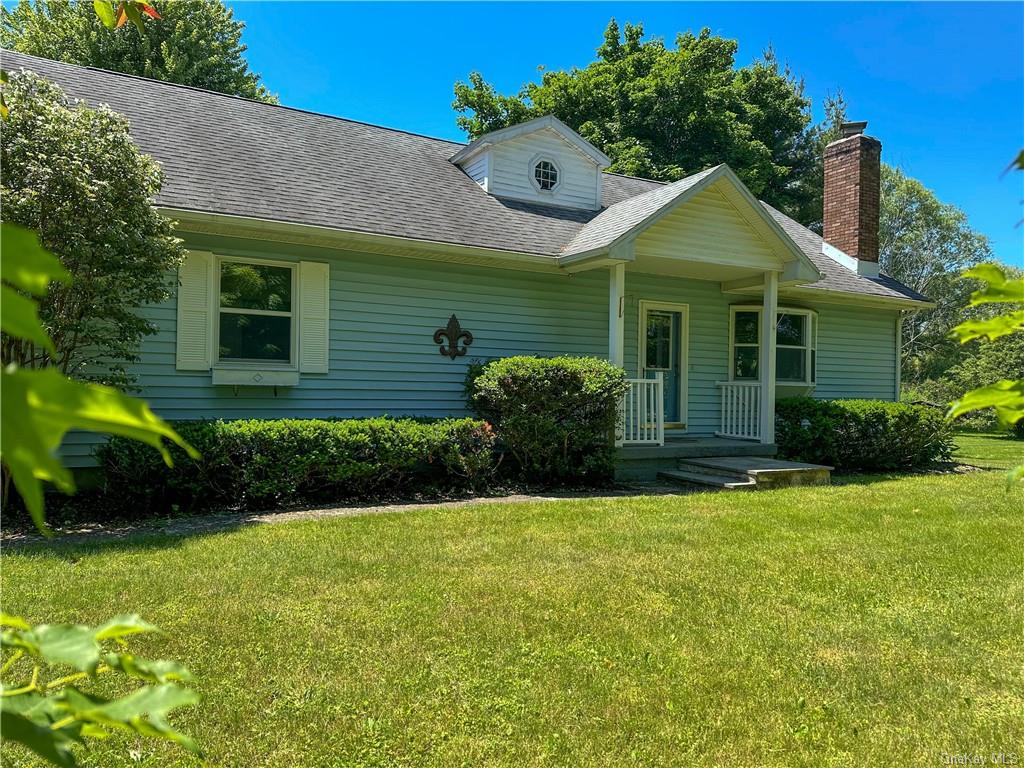 a front view of a house with a garden and plants