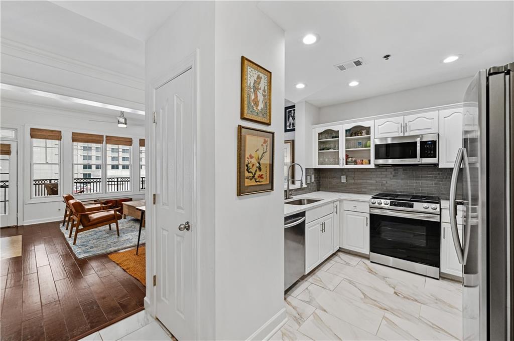 a kitchen with stainless steel appliances granite countertop a stove and a refrigerator