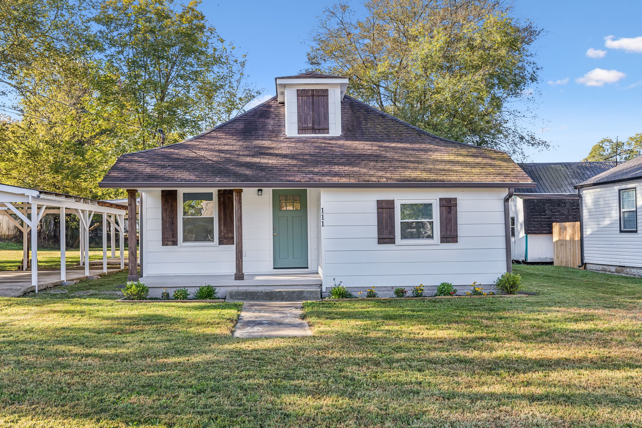 a front view of a house with a garden